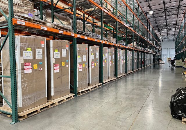 Warehouse aisle with stacked pallets and boxes